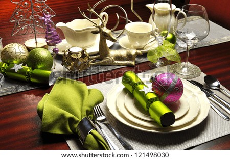 Festive Christmas Eve Dinner Table Setting on dark oak table with lime green and pink accents.