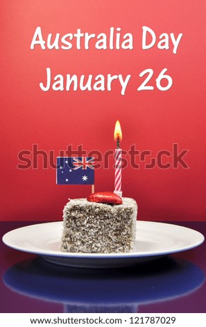 Australia Day January 26, celebration with lamington cake, candle and Australian flag, with text.