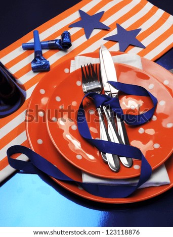 Football table settings for party celebration in navy blue, orange and white. (Portrait vertical orientation)