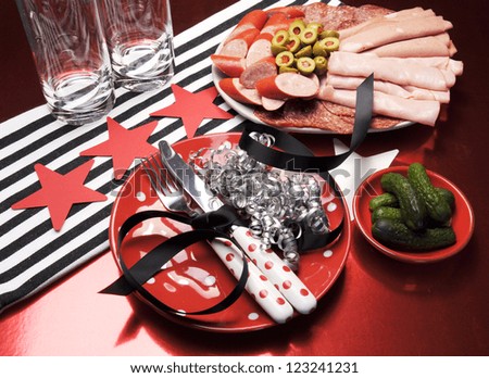 Celebration party table setting in red, black and white, with party food.