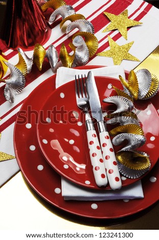 Celebration party table settings  in red, metallic gold and white team colors. (Portrait vertical orientation)