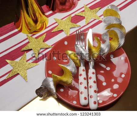 Football celebration party table settings  in red, metallic gold and white team colors.