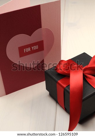 Special occasion handmade gift card, \'For You\', with black box gift and red ribbon on white natural wood table, for Valentine, Christmas, Easter, birthday, or Mothers Day.