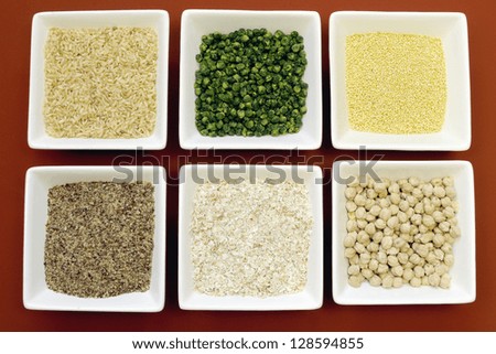 Gluten free grains food - brown rice, millet, LSA, buckwheat flakes and chickpeas and green peas legumes - for a healthy diet free of celiac disease. Close-up.