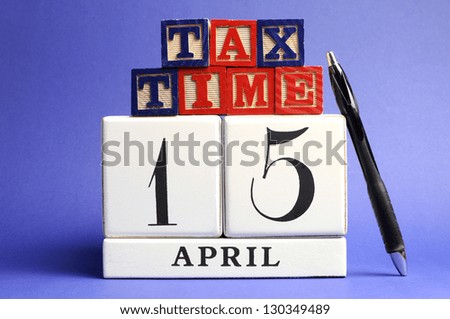 Save the Date, April 15, USA Tax Day with white calendar and red, white and blue building block letters - tax time - on blue background.