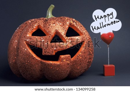 Happy Halloween orange color fun pumpkin Jack-o-lantern with scary face and red heart sign and message on black background.