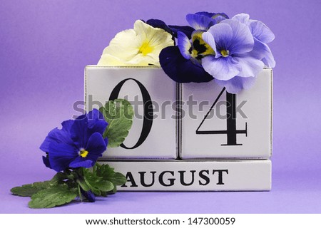Save the Date white block calendar for August 4, International Friendship Day, decorated with blue and white pansy violas on blue purple background.