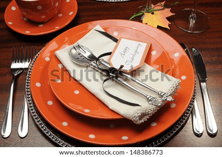Beautiful Autumn Fall theme Thanksgiving dinner table place setting with Happy Thanksgiving tag attached to silverware.