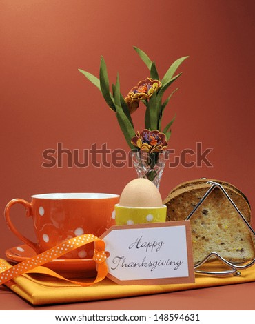 Happy Thanksgiving breakfast for your special one with toast and egg with coffee or tea in an orange polka dot cup and saucer, with heartfelt gift tag. vertical.