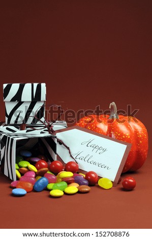 Happy Halloween trick or treat black and white zebra candy boxes with orange pumpkin. Vertical with copy space.