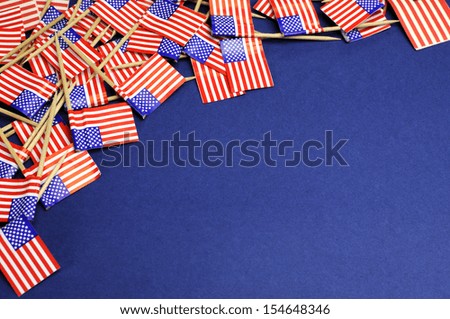 Abstract background of USA red, white and blue Stars and Stripes national toothpick flags for travel, national emblem, food background, or public holiday event, with copy space for your text here.