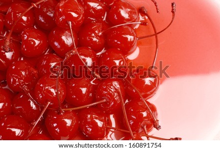 Festive background of red cocktail maraschino cherries with stems - with copy space for your text here.