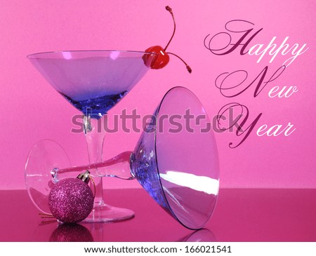 Pink theme Happy New Year party with vintage blue martini cocktail glass and New Years eve decorations against a pink background, with greeting text.
