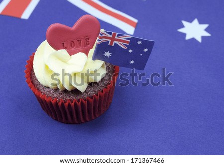 I Love Australia cupcake with love heart and Australian Flag for Australia Day or Anzac Day holidays, against an Australian flag background, with copy space.