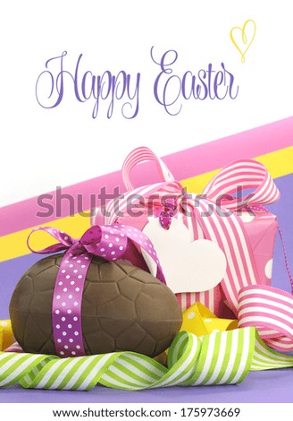 Colorful pink, yellow and purple theme Happy Easter theme with chocolate egg and gift box with sample text or copy space.