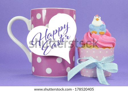 Happy Easter pink, yellow and blue cupcakes with cute chicken decorations on purple background and pink polka dot coffee mug with gift tag and greeting.