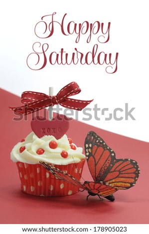 Red theme cupcake with butterfly on red and white background with Happy Saturday sample text or copy space for your text here.