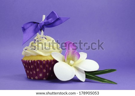 Purple theme cupcake with orchid flower for wedding, bridal or baby shower, mothers day, or female birthday.