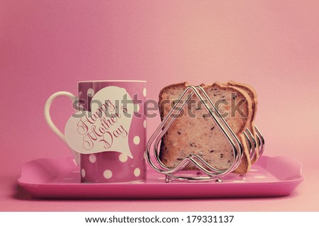 Retro vintage old fashion style Happy Mothers Day breakfast with toast and polka dot coffee tea cup and heart shape rack on faded pink background.