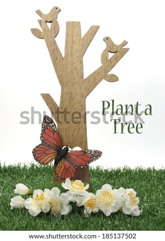 Happy Arbor Day, Plant a Tree greeting for last Friday in April, with wood tree, carved birds, butterfly and green grass on white background with sample text or copy space.