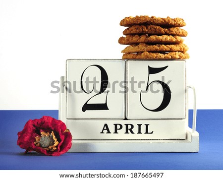 White shabby chic vintage style block calendar for Anzac Day, April 25, with traditional Anzac biscuits on white background with remembrance red poppy
