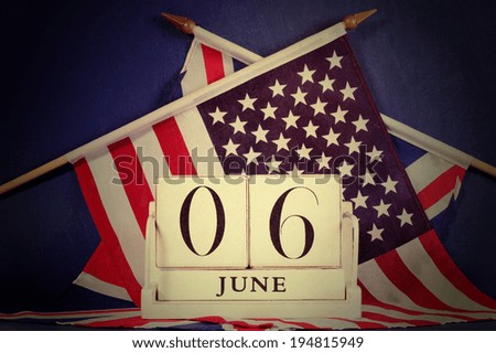 Retro vintage style D-Day calendar for anniversary of 6 June against a dark blue grunge background and USA stars and stripes and British UK Union Jack flags