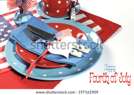Happy Fourth of July dining table place setting in red, white and blue color theme with USA Stars and Stripes flag and heart gift tag with sample text.