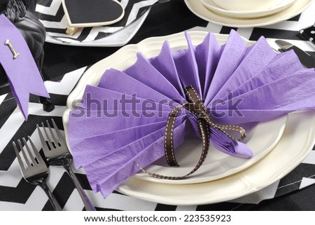 Black and white chevron with purple theme party luncheon table place setting for Melbourne Cup, Australian public holiday, horse race event - closeup.