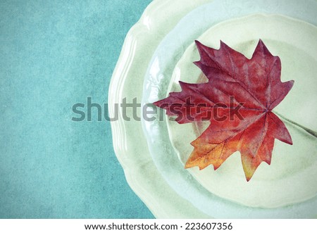 Retro vintage style Thanksgiving Fall dining table elegant place setting in pale aqua blue and white theme with autumn leaf, with copy space.