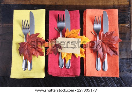 Happy Thanksgiving table place setting with We Gather Together place card and autumn fall leaf decorations