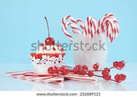 Christmas holiday dessert party candy canes with cupcake in modern red and white trend on pale blue and white background.
