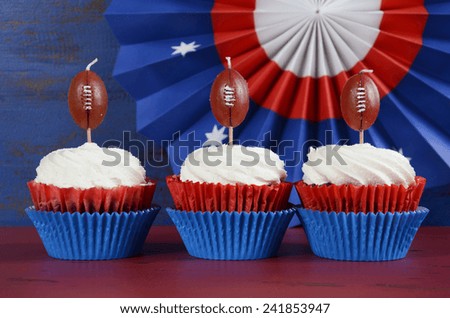 Red, white and blue theme cupcakes with football toppers for Super Bowl Sunday party or collage football finals and playoffs.