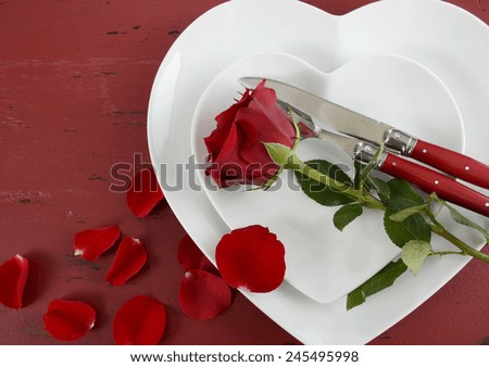 Happy Valentines Day table place setting on red vintage wood background with red rose, with copy space.