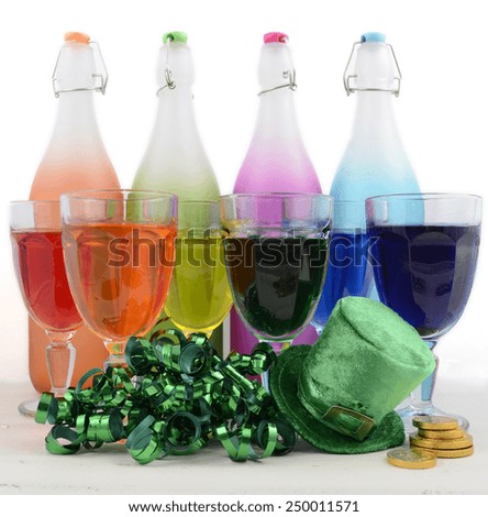 Happy St Patricks Day party rainbow color drinks with decorations on vintage wood table.