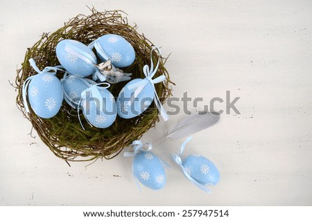 Happy Easter blue and white theme eggs on white wood table background.