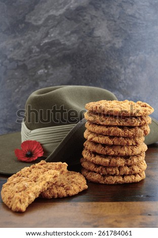 Australian Anzac biscuits with soldier slouch hat on dark vintage background.
