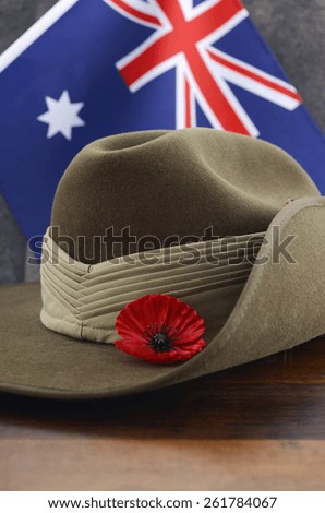 Anzac army slouch hat with Australian Flag on vintage wood background.