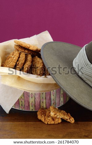Australian Anzac biscuits in vintage biscuit tin with army soldier slouch hat.