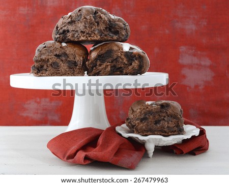 Chocolate Fruit Buns on White Cake Stand on white shabby chic wood table with red wallpaper background.