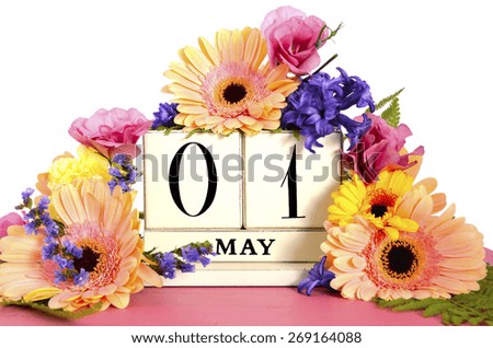 Happy May Day vintage wood calendar decorated with Spring flowers on pink wood table.