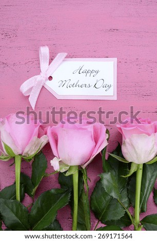 Happy Mothers Day Pink Roses on Vintage style distressed pink wood table with gift tag.