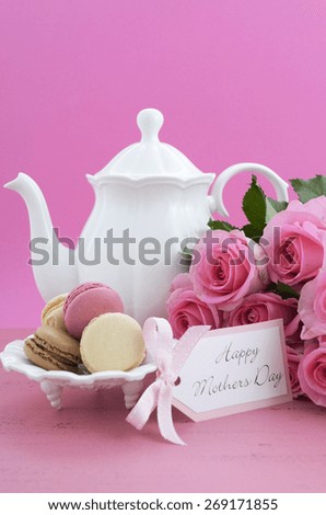 Happy Mothers Day Pink Roses and Tea Pot and tea setting on shabby chic style vintage distressed pink wood table. .