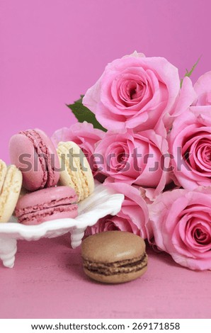 Happy Mothers Day Pink Roses and macarons on vintage style distressed pink wood table.