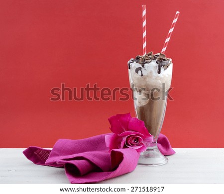 Iced coffee drink in classic soda pop glasses in modern cafe style red and pink background on white vintage wood table, with copy space.