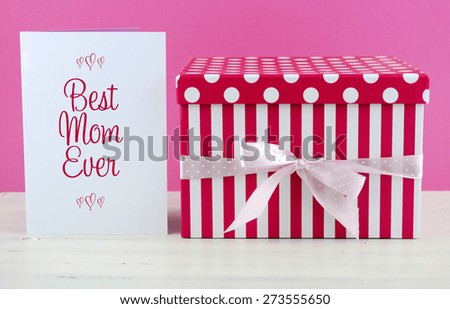 Happy Mothers Day pink and white gift with Best Mom Ever greeting card, on white shabby chic distressed wood table.