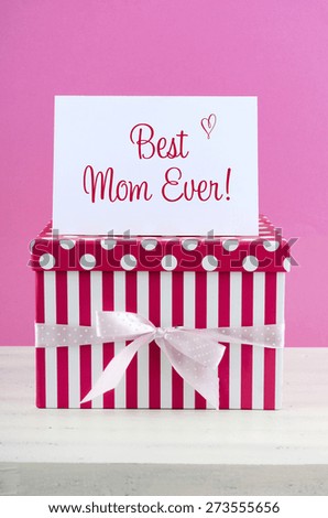 Happy Mothers Day pink and white gift with Best Mom Ever greeting card, on white shabby chic distressed wood table.