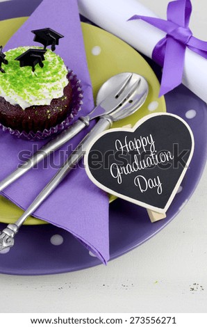 Graduation Day green and purple theme party with cupcakes and graduation cap toppers.