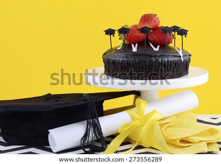 Happy Graduation Day yellow, black and white theme party with chocolate cake and strawberries.