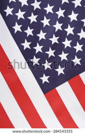 USA Stars and Stripes Flag on Dark Wood, close up, vertical.