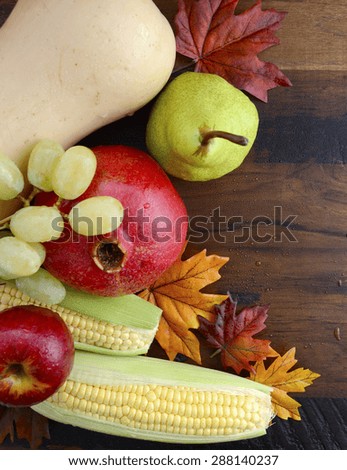 Autumn Fall harvest fruit and vegetables on dark vintage reclaimed wood for Thanksgiving, Halloween and Fall background with copy space.